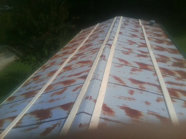 Rusted metal roof panels with new wood purlins before replacement — Storm Damage Roof Repair in Terrebonne by Roofing Brothers